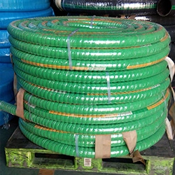 Green industrial hose coiled on a pallet.